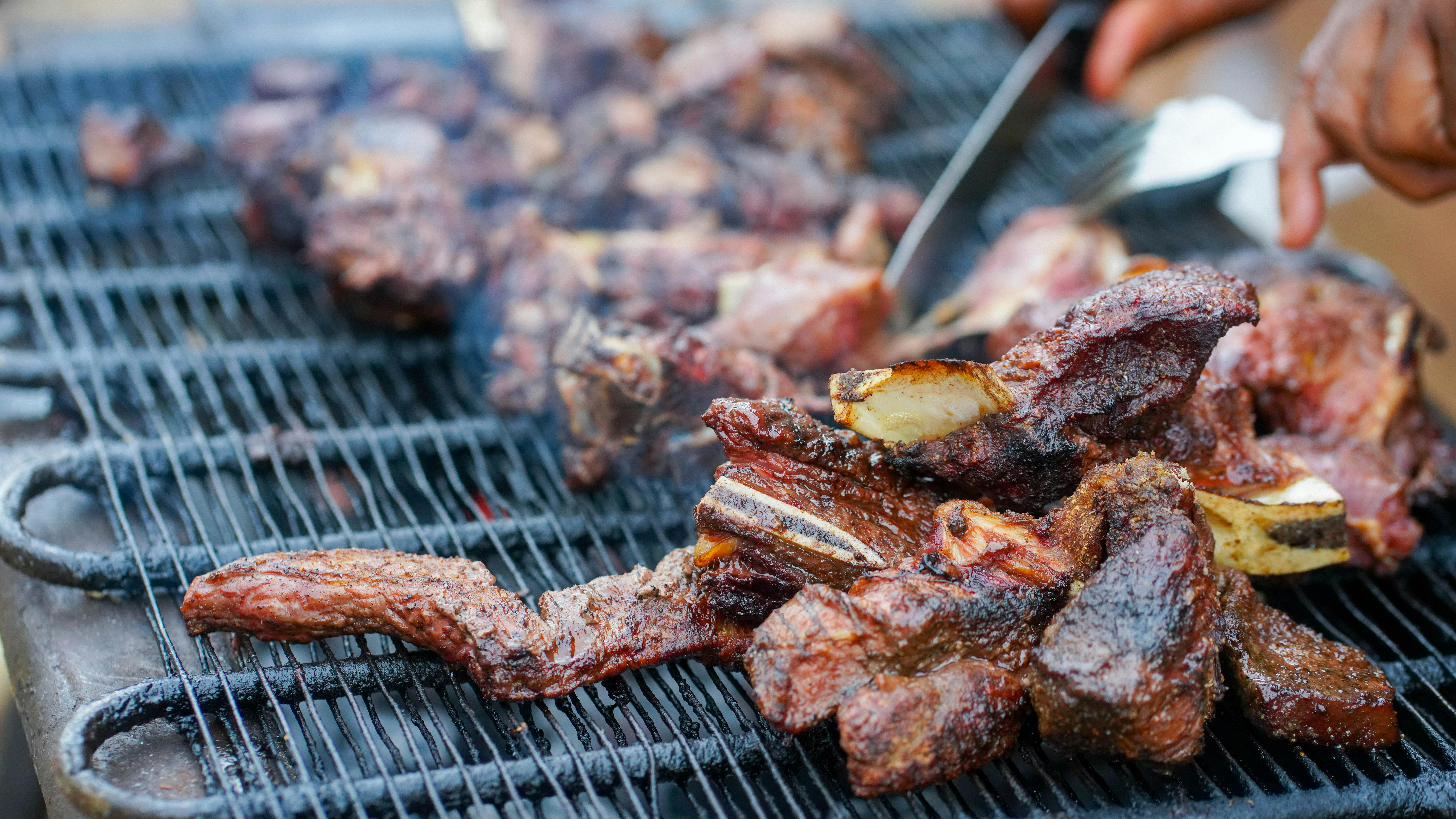 Smoked ribs sizzling on the grill.